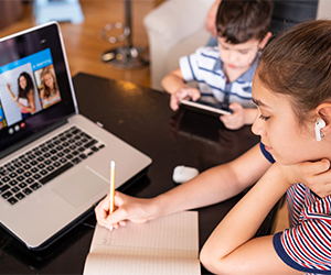 Children focusing on their online school