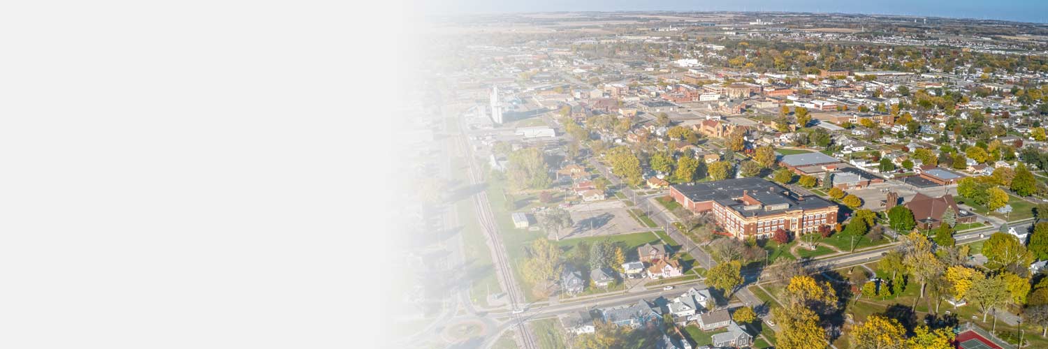 A sky view of Norfolk, NE in autumn that shows grass, trees, streets, houses and buildings