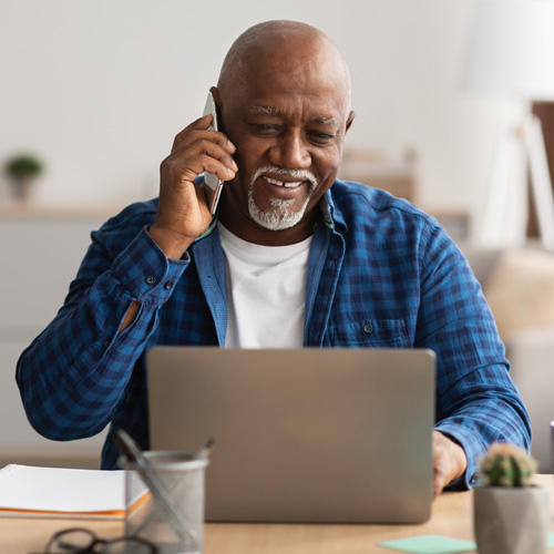 A mature man feeling happy by getting help over the phone for owned modems